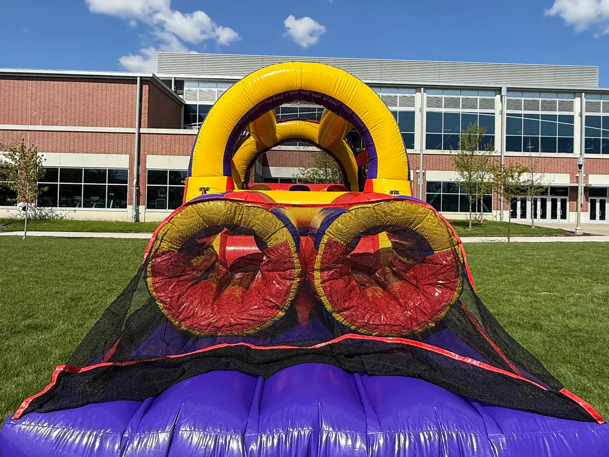 Dual lane inflatable obstacle course set up for a Chicago backyard party.